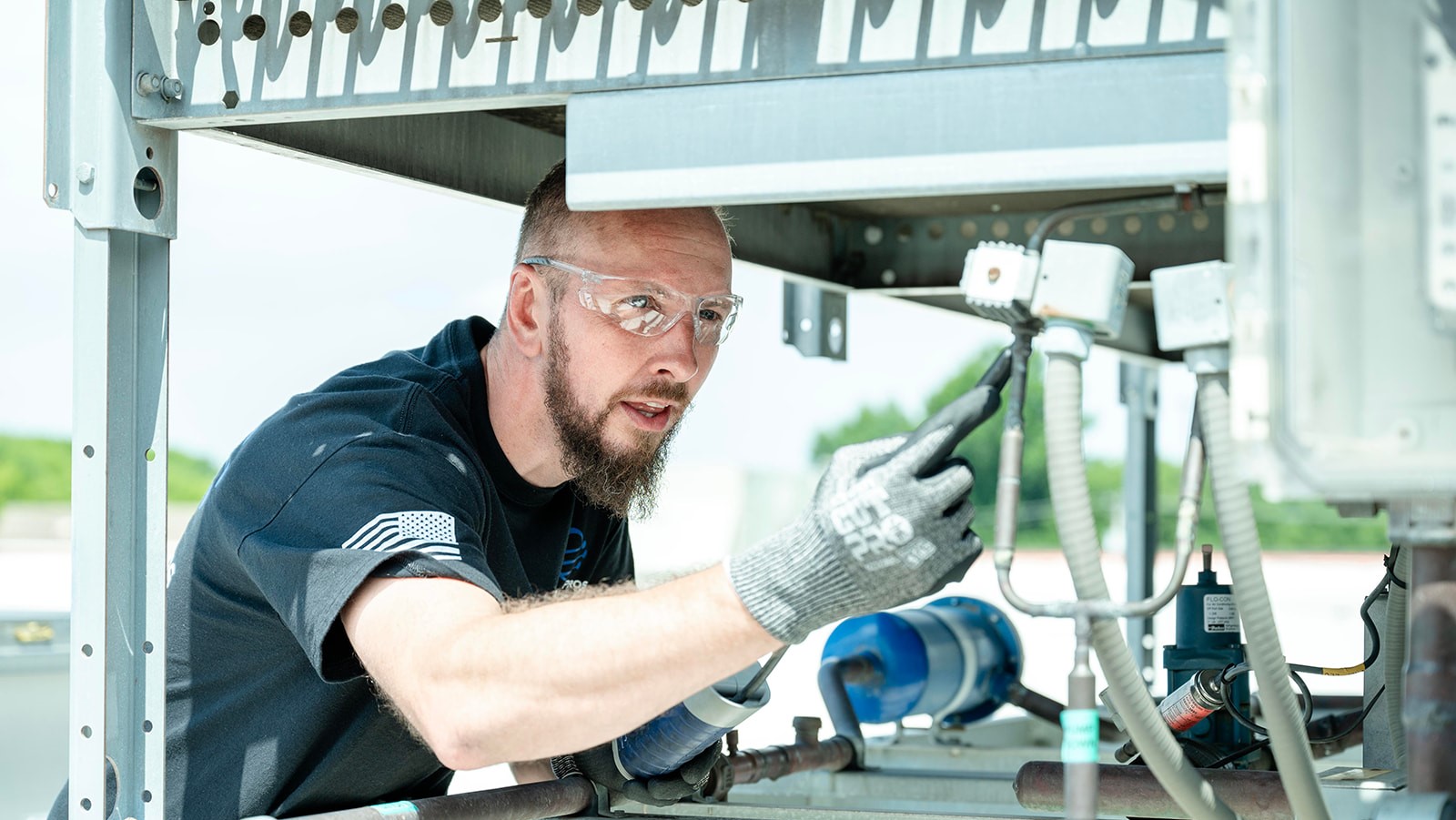 Climate Pros technician in personal protective equipment on a job site
